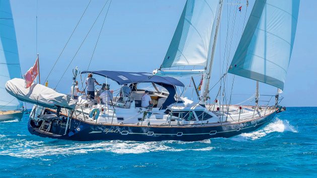 The yacht sailing on relatively calm water. The boat has two sails