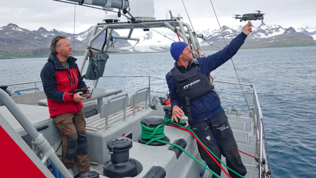 Kelvin and Dion launching the drone to survey an islet in the Bay of Isles