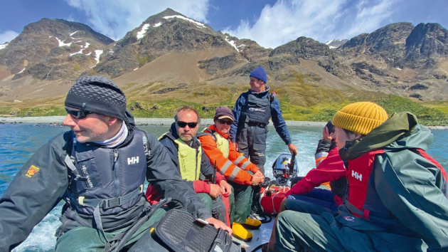 Survey team about to land at Whistle Cove, Fortuna Bay, on the north coast.